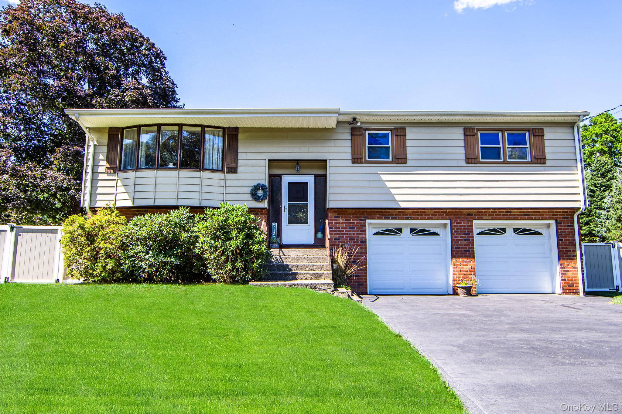 Beautifully maintained high ranch with expansive backyard retreat !