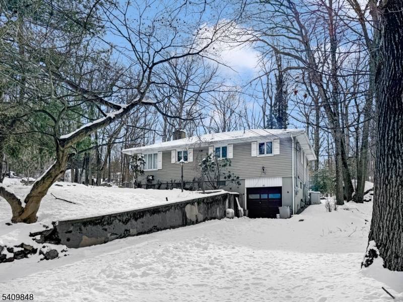 Hidden paradise best describes this home on a double, separate deed lot measuring 120x240, featuring blue stone patios, a built in stone barbecue grill, a waterfall, and a pond.