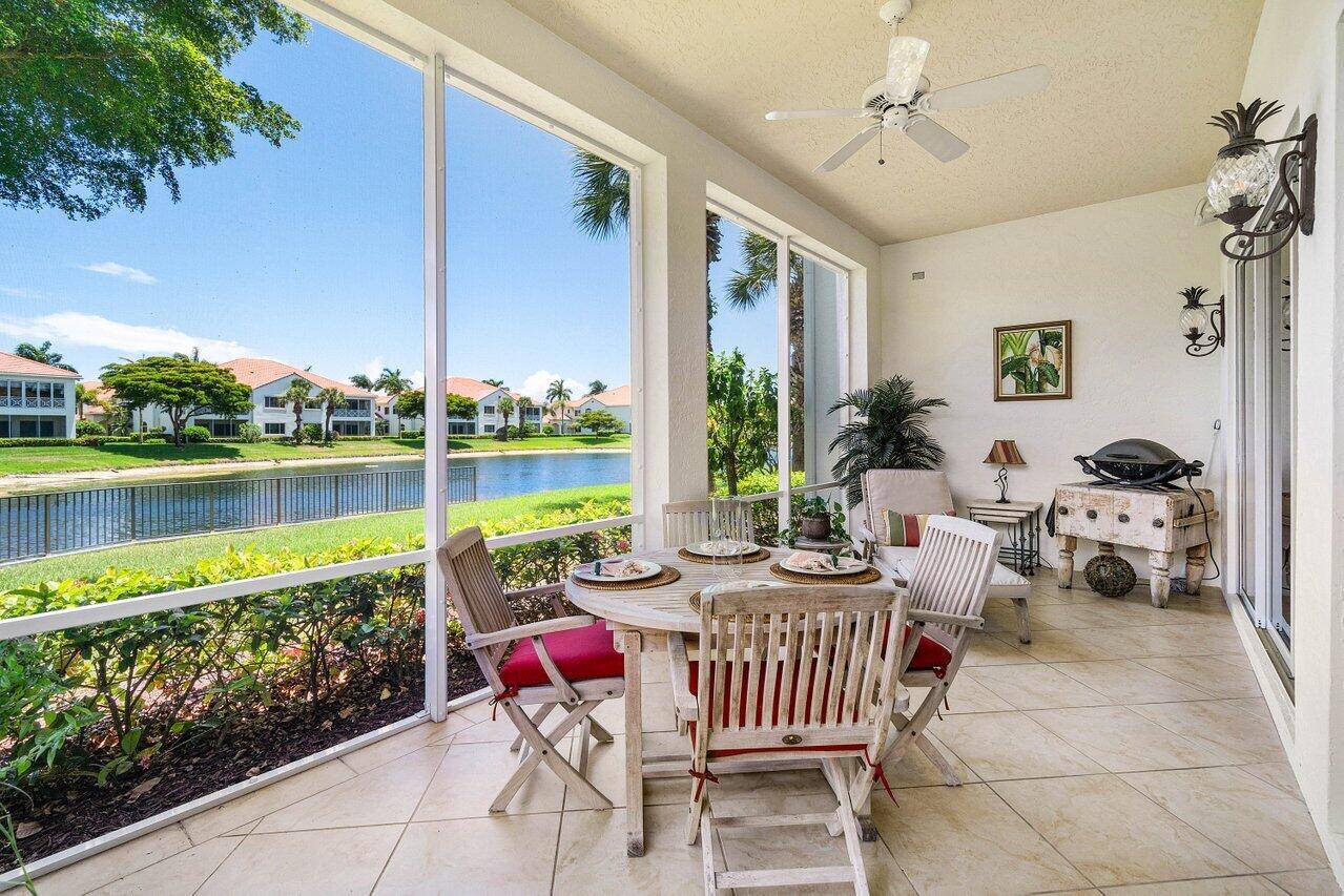 Experience the ultimate in luxury and privacy in this beautifully maintained 1st floor end unit in the exclusive Palm Bay Club at BallenIsles Country Club.