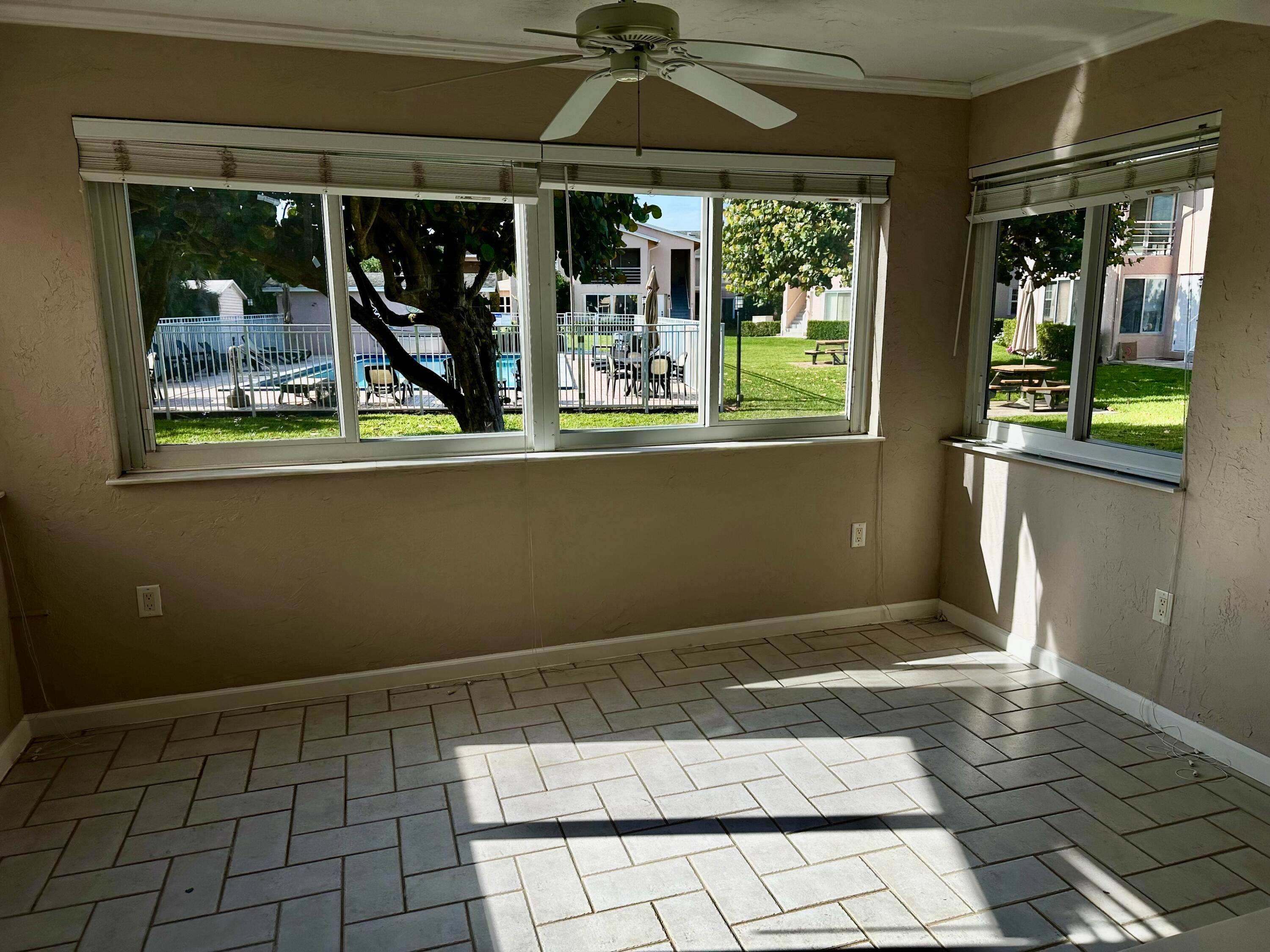 This charming unit, located at the back of the community, offers a serene atmosphere complemented by breathtaking views of the lush greenery surrounding the pool.