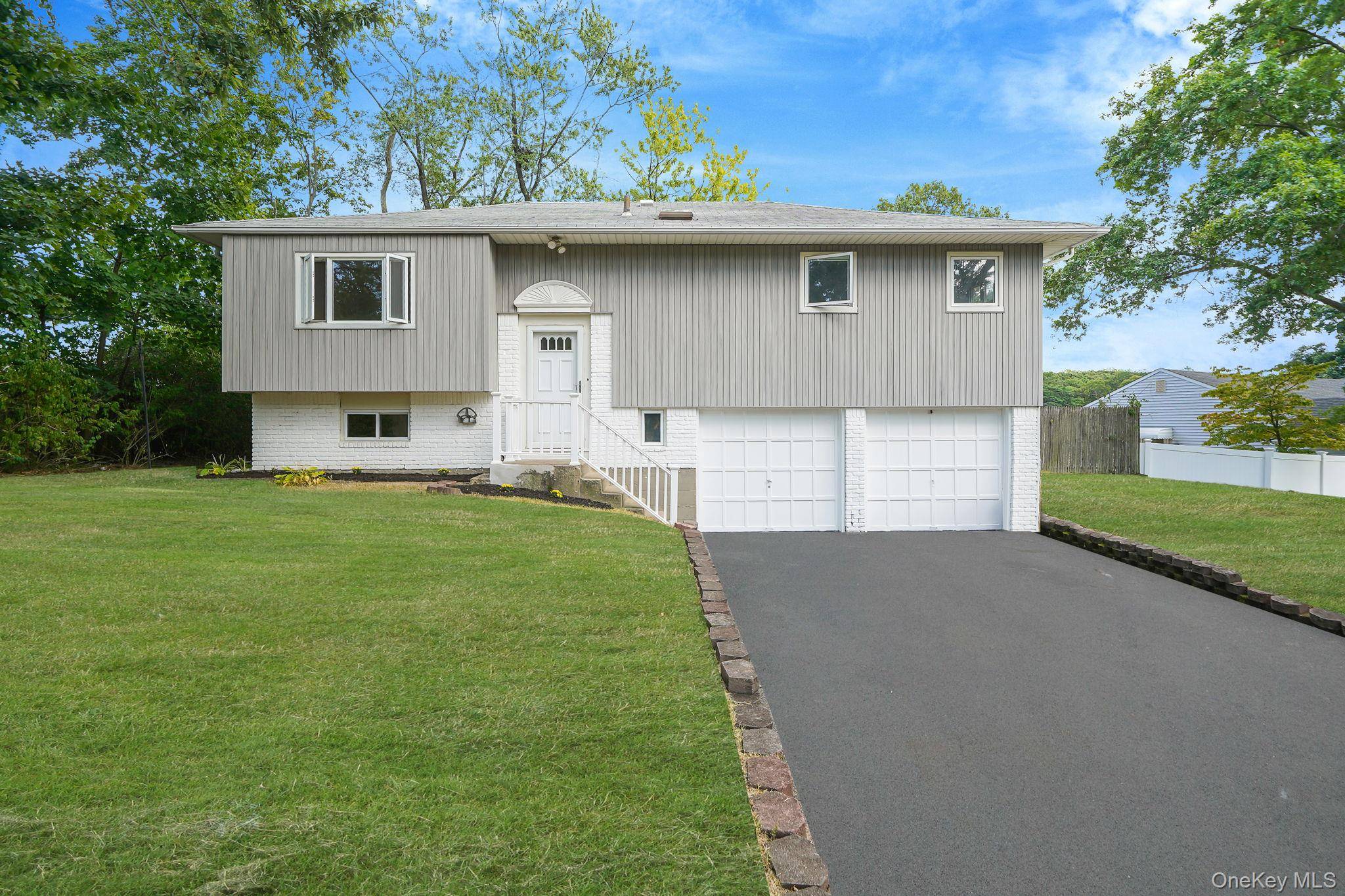 Welcome to this beautifully renovated high ranch tucked away on a quiet cul de sac in the heart of Smithtown.