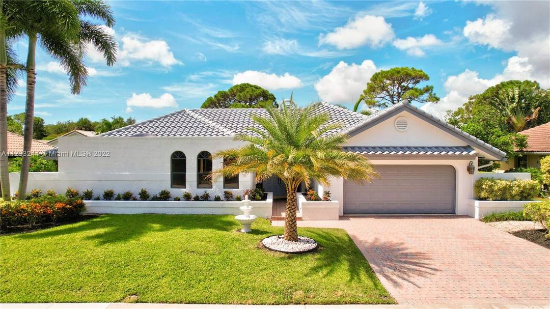 Located in the highly sought after New Floresta community, this exceptional residence showcases timeless Spanish architecture and an upscale feel in the heart of East Boca.