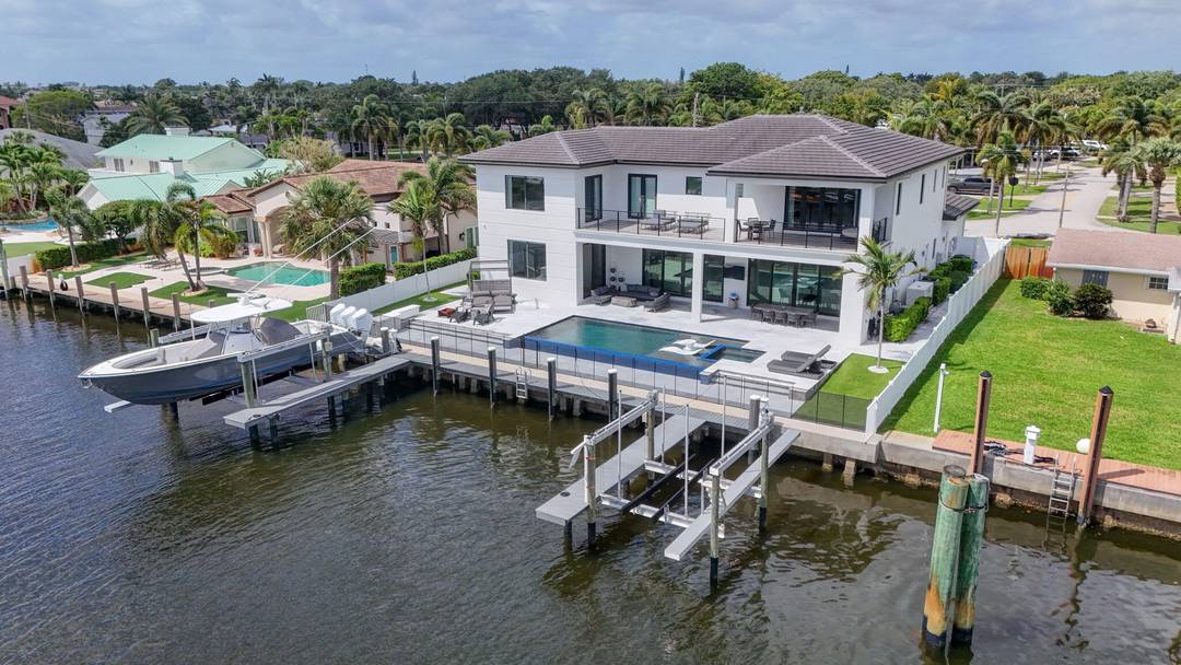 Experience the pinnacle of waterfront living from this exceptional two story Intracoastal estate, offering over 5, 300 square feet of exquisitely designed living space.