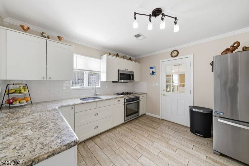 EXCEPTIONAL CUSTOM HOME all redone Set on 55x100 private, beautifully landscaped yard in one of Parlin's most coveted neighborhoods, this Colonial blends timeless elegance w modern comfort.