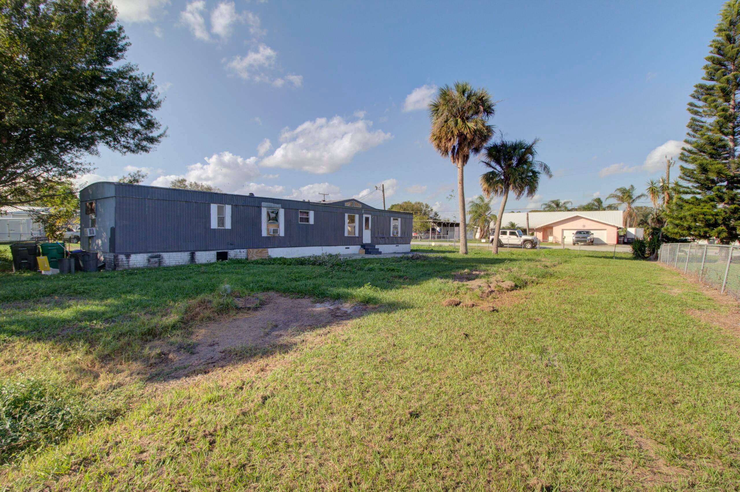 Treasure Island Canal front 3 bedroom mobile home on a flat, cleared, fenced lot in Okeechobee.