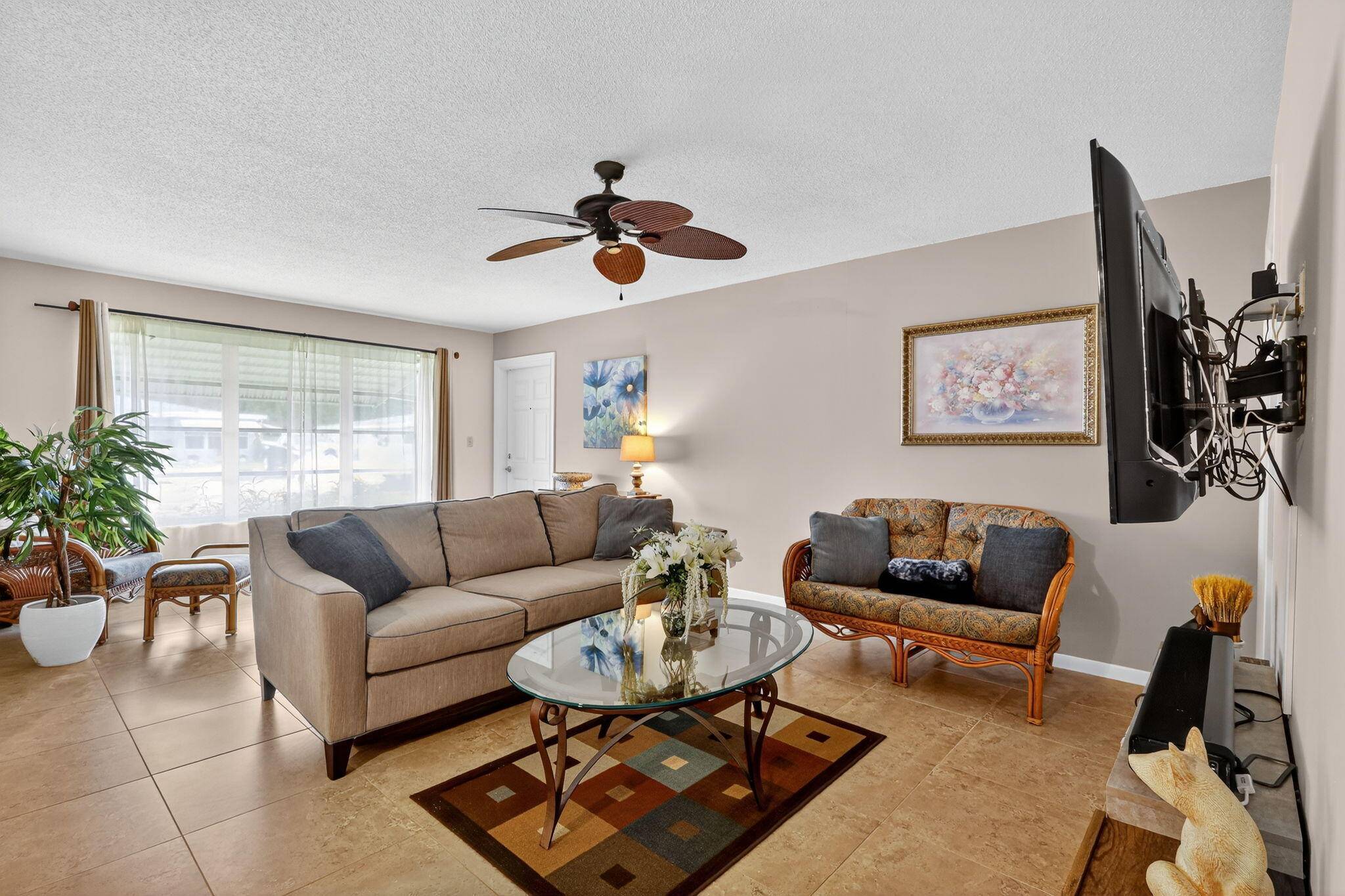 Stunning, updated furnished villa, in the vibrant 55 community of High Point, The open concept living and dining area, with ceramic tile, flows effortlessly.