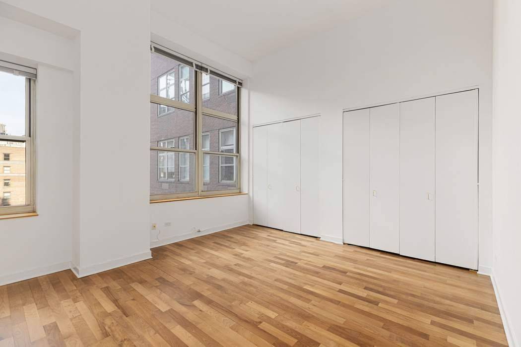 Step into this dramatic, loft like studio where soaring 13 foot ceilings and oversized windows fill the living and sleeping space with abundant natural light.