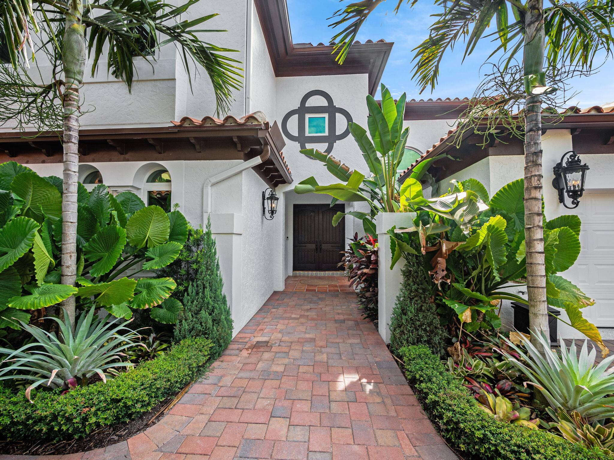 Welcome to 3299 Bridgegate Drive, a rare waterfront gem in Jupiter's sought after Jonathan's Landing community.