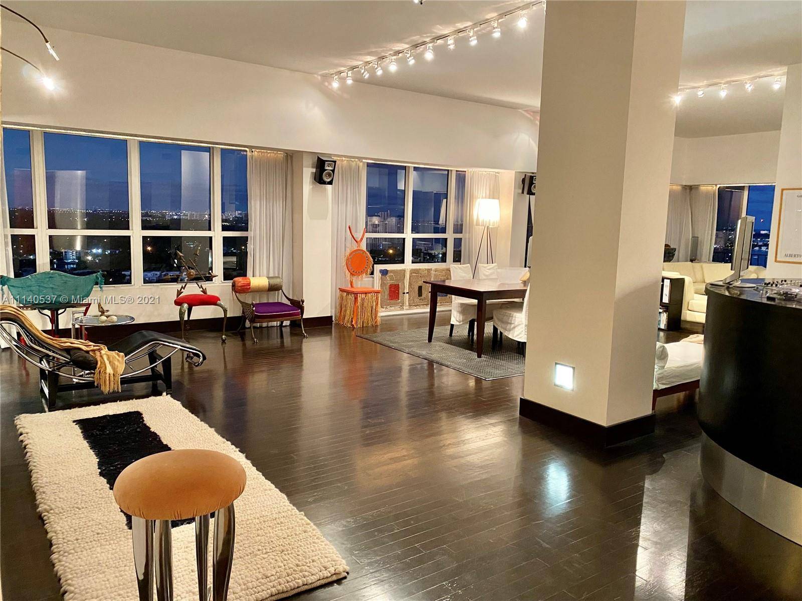 Openheim architecture and design in this chic top floor corner unit with wraparound 24' balcony over Biscayne Bay.