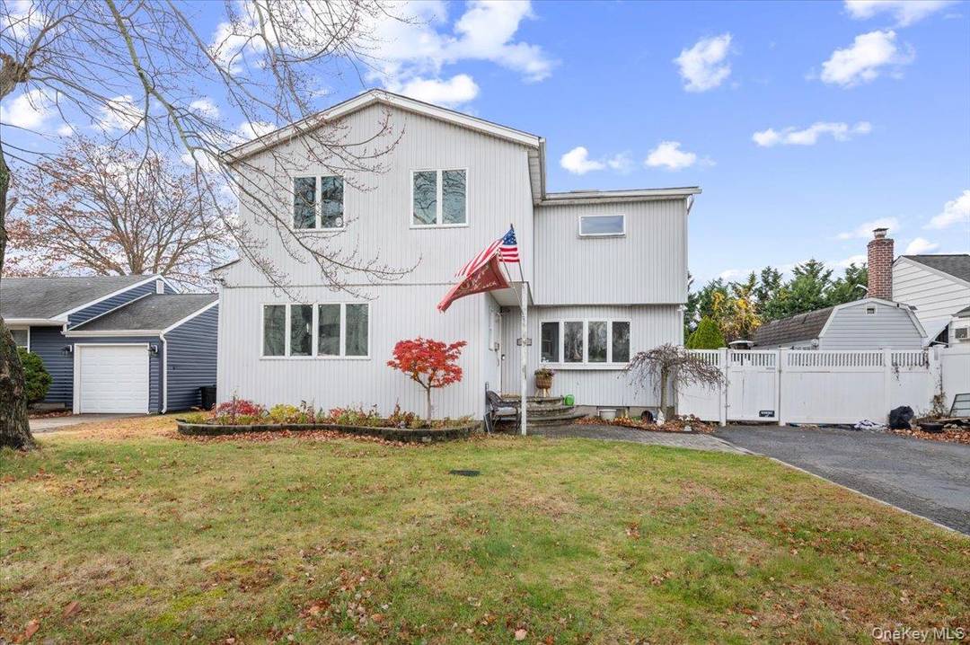 Discover the charm and versatility of this 4 bedroom, 4 bathroom colonial home in Hicksville.