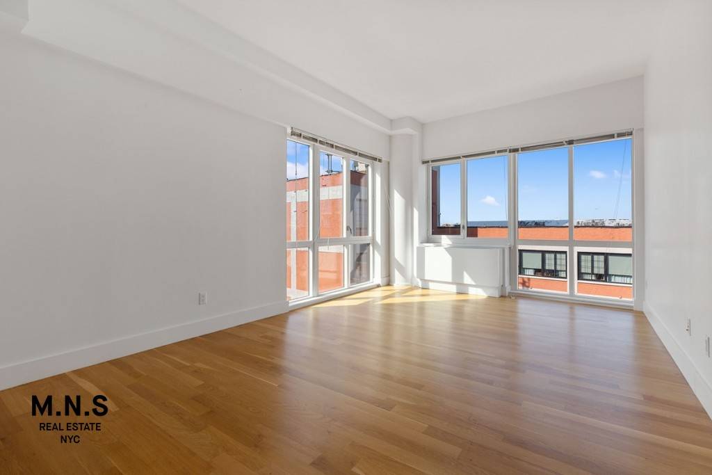 This unit features hardwood floors and oversized floor to ceiling windows which flood the unit with natural light.