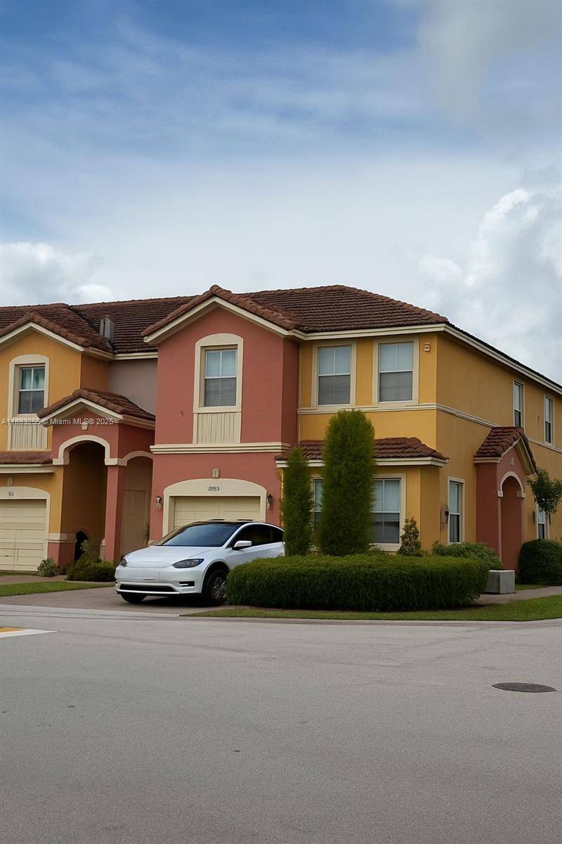 Spacious 4 bedroom, 3 bathroom corner townhouse with private driveway and one car garage partially converted offering comfort and style.