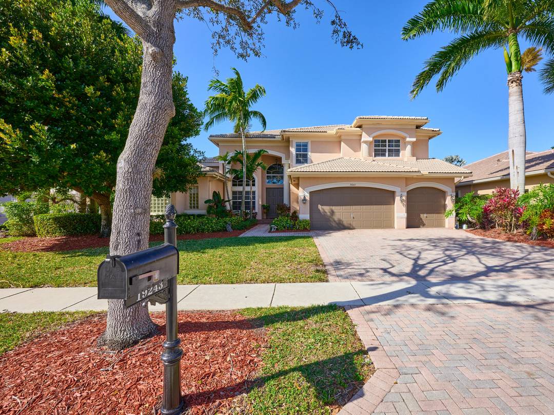 LAKEVIEW RENOIR MODEL ON A QUIET CUL DE SAC featuring a lush landscaped front entrance.