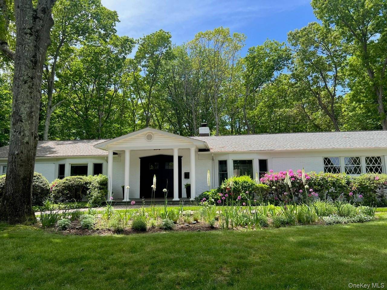 Completely renovated 1964 four bedroom Ranch with central heat gas and AC in Belle Terre on 1 acre.