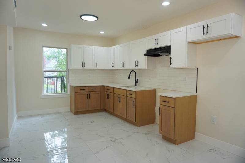 Welcome to this stunningly renovated two family home located on a quiet, well maintained block in the heart of East Orange.