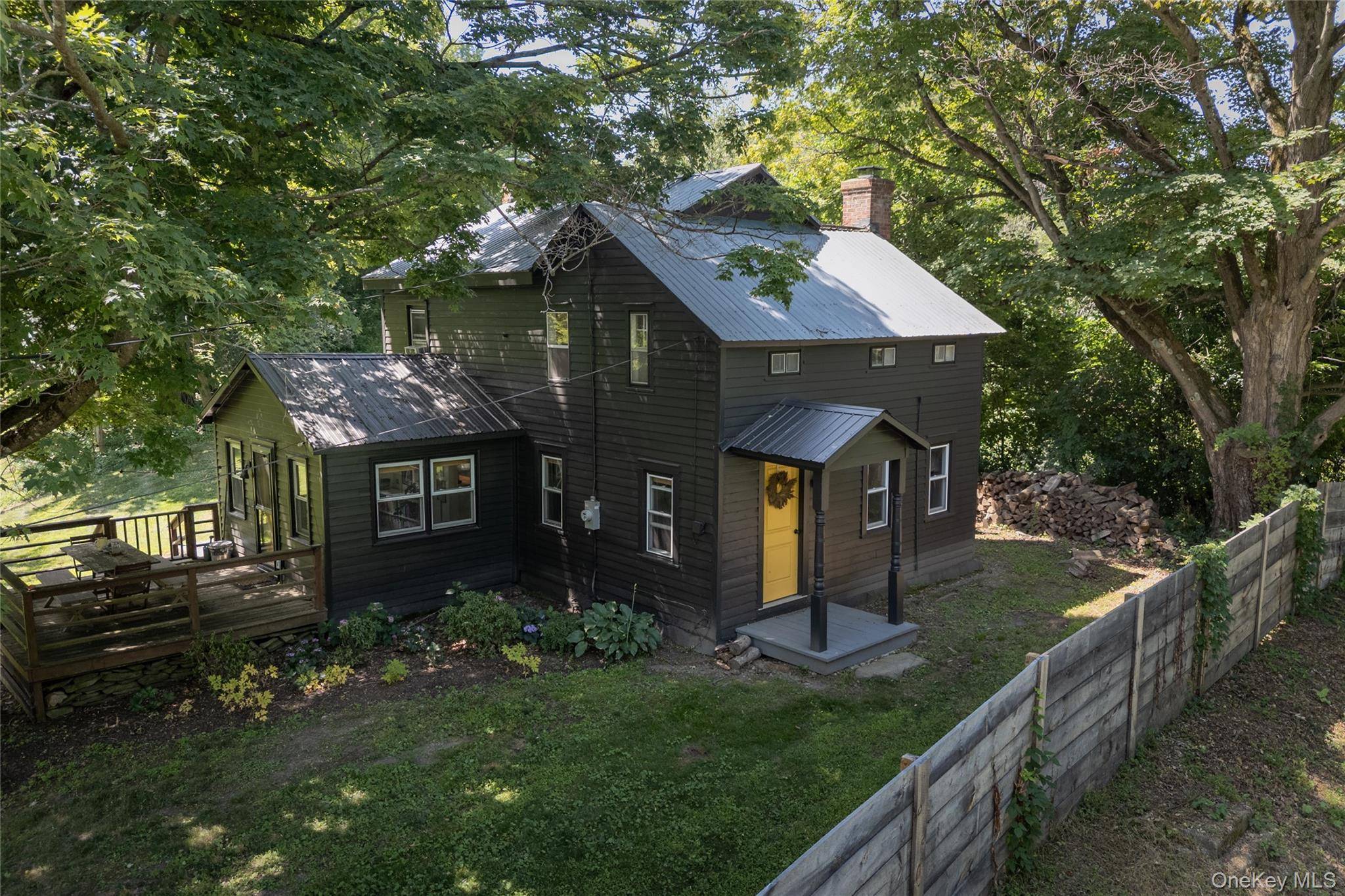 Meadowood is an 1840 farmhouse, full of enduring charm, that sits on nearly eight acres of open lawns, mature trees, and woodland just outside Hudson.