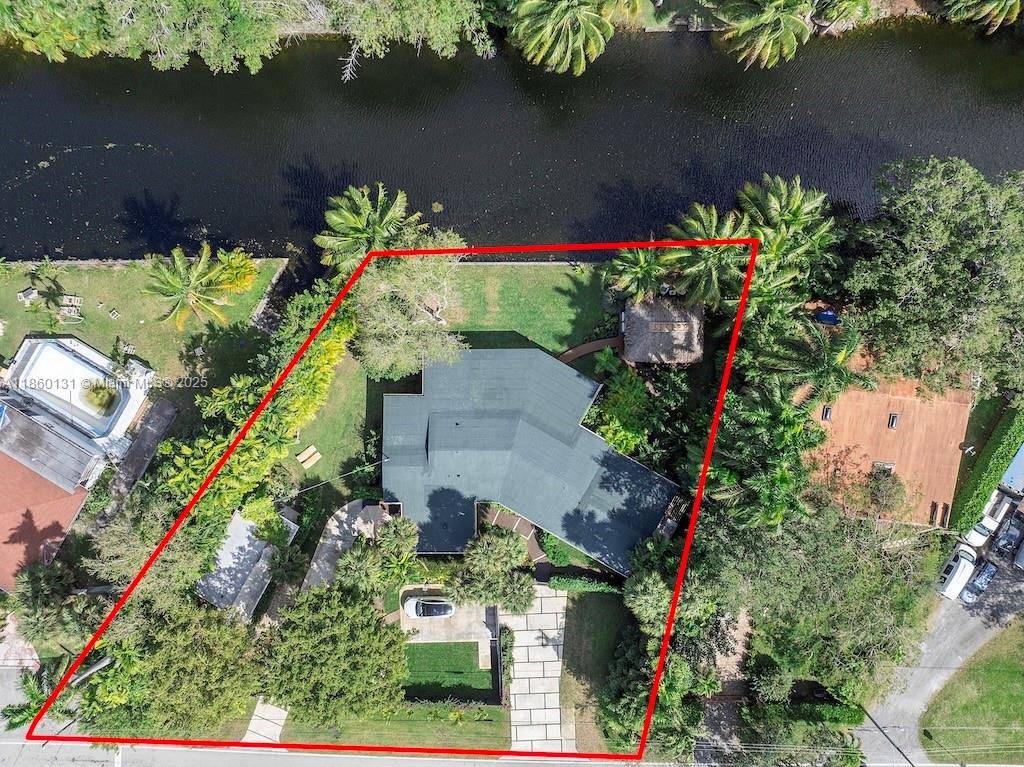 Nestled along a serene canal, this fully renovated home is a private tropical retreat.