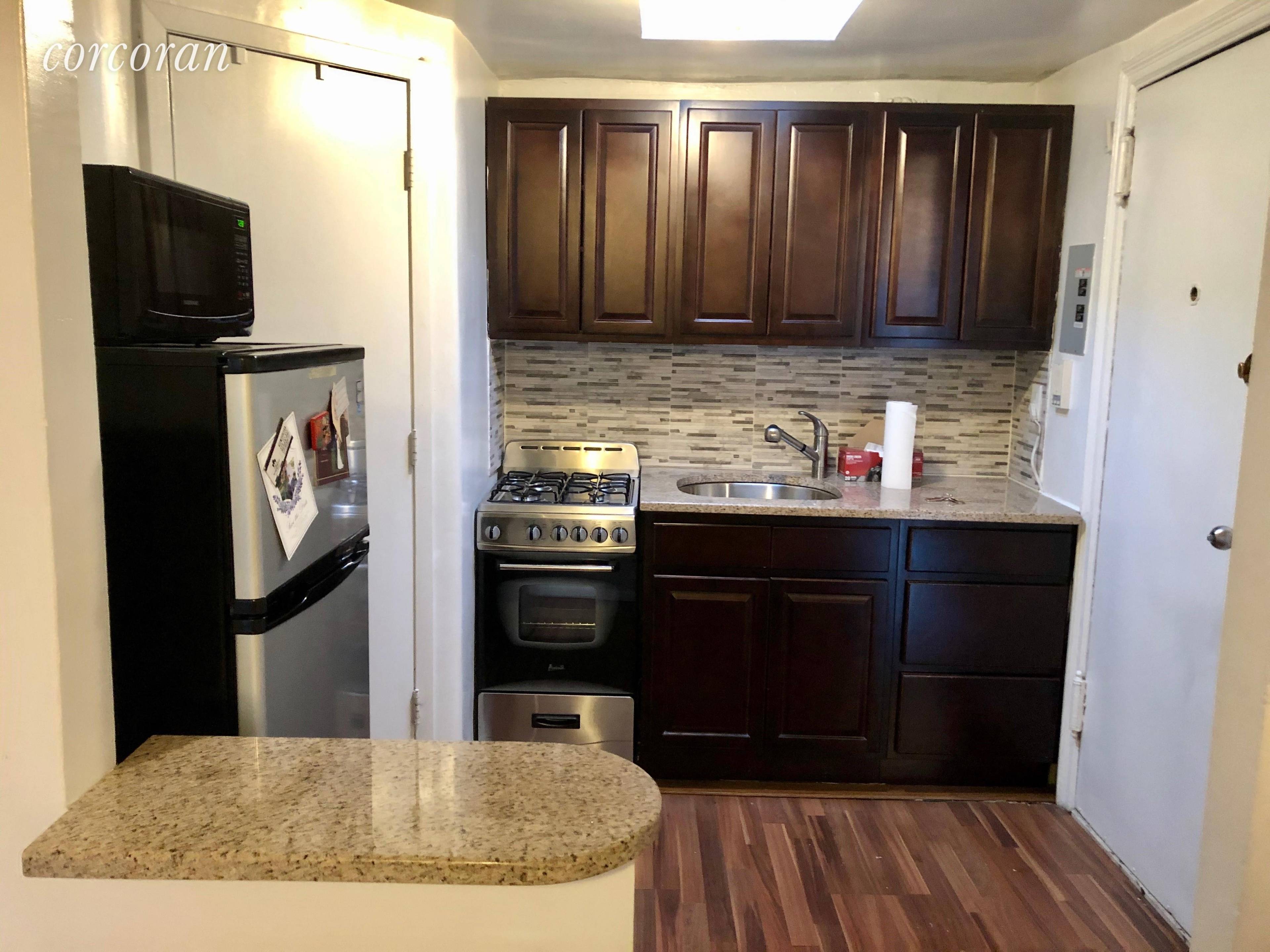 Charming two bedroom with new hard wood floors, two skylights, a renovated open kitchen and new bathroom.