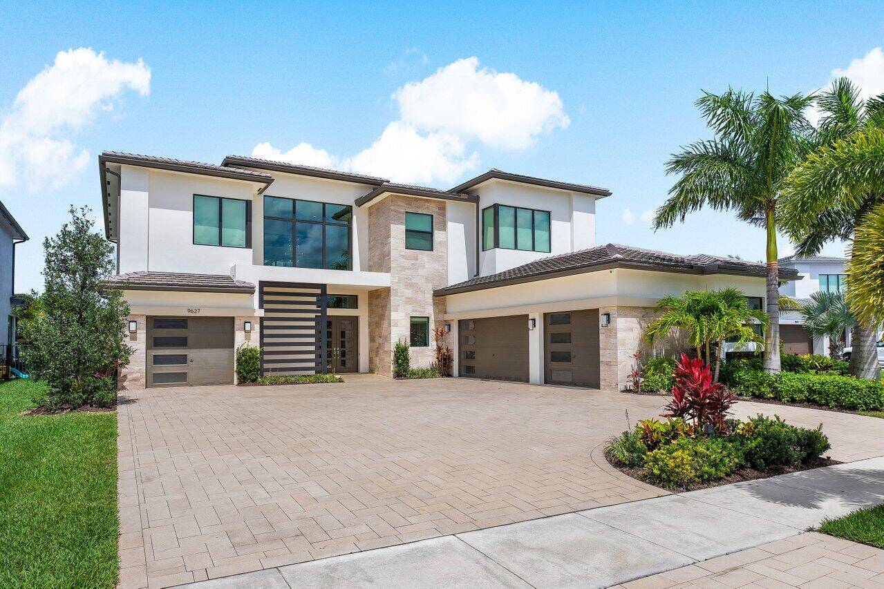 Introducing an exquisite modern estate nestled within the prestigious Boca Bridges, where luxury living meets chic elegance.