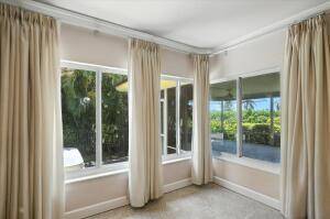 Mid century bungalow on a corner lot directly on the golf course in Lake Worth Beach.