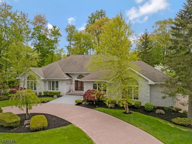Impeccably maintained custom ranch style home on a private 2.