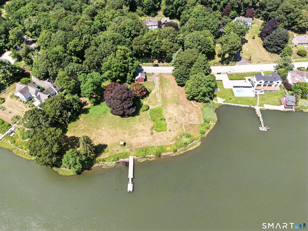 An exceptional waterfront lot offering the rare opportunity to own almost 1 acre of level coastal property in prime Stonington.