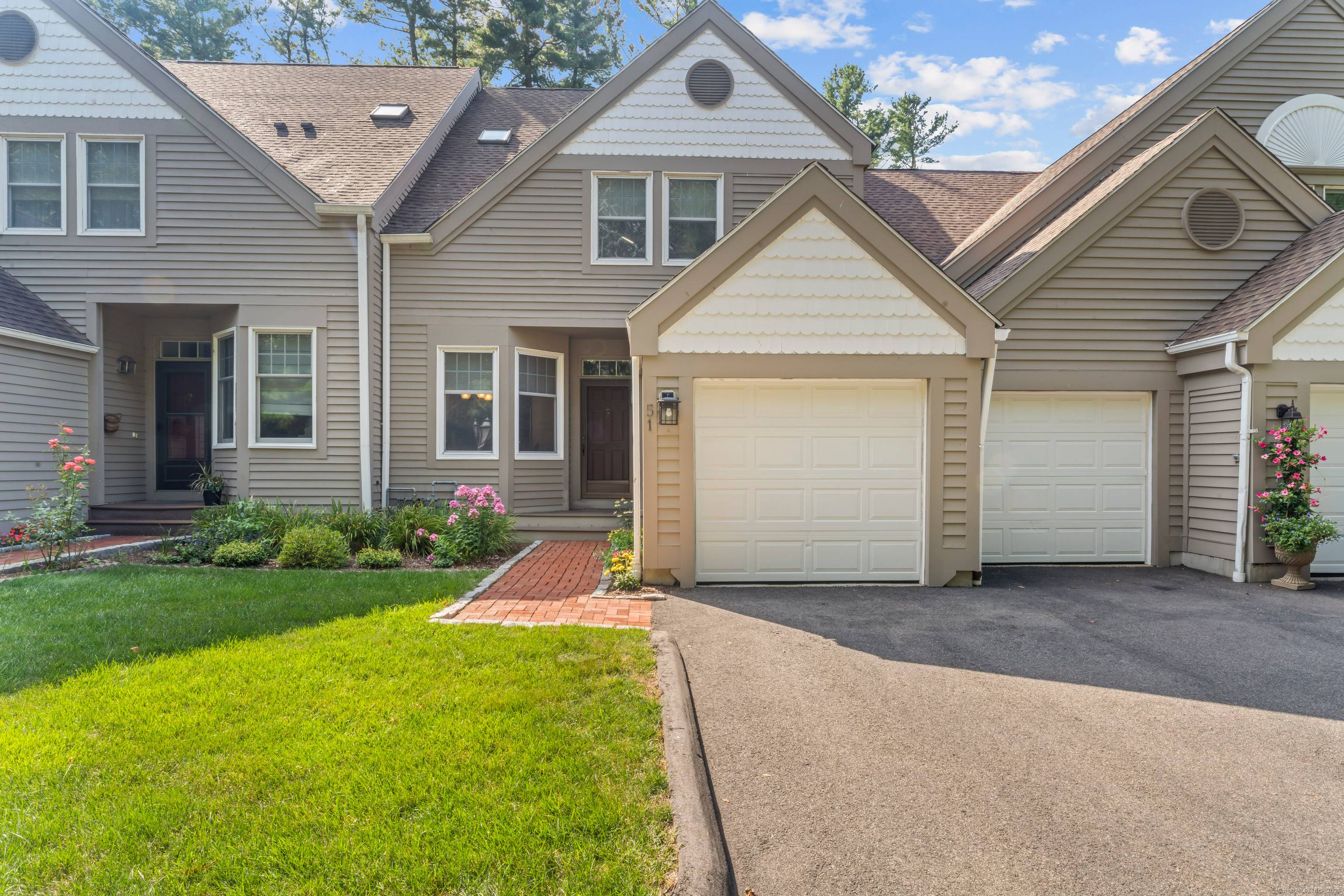 Nestled in the picturesque village of Huntington, this stunning Victorian style townhome offers timeless curb appeal and serene living in the sought after Greystone on the Lake community.