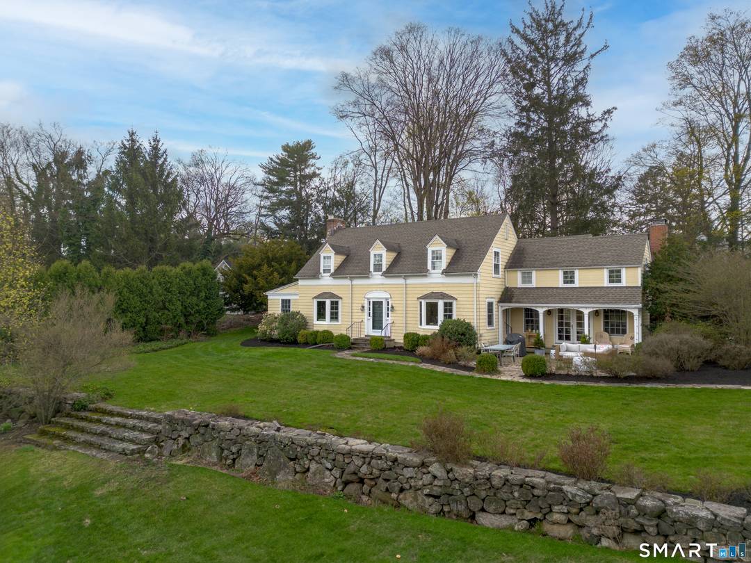 Set on nearly two acres of beautifully landscaped, park like grounds, this enchanting 1930s Colonial is tucked away on a private cul de sac just moments from the village and ...