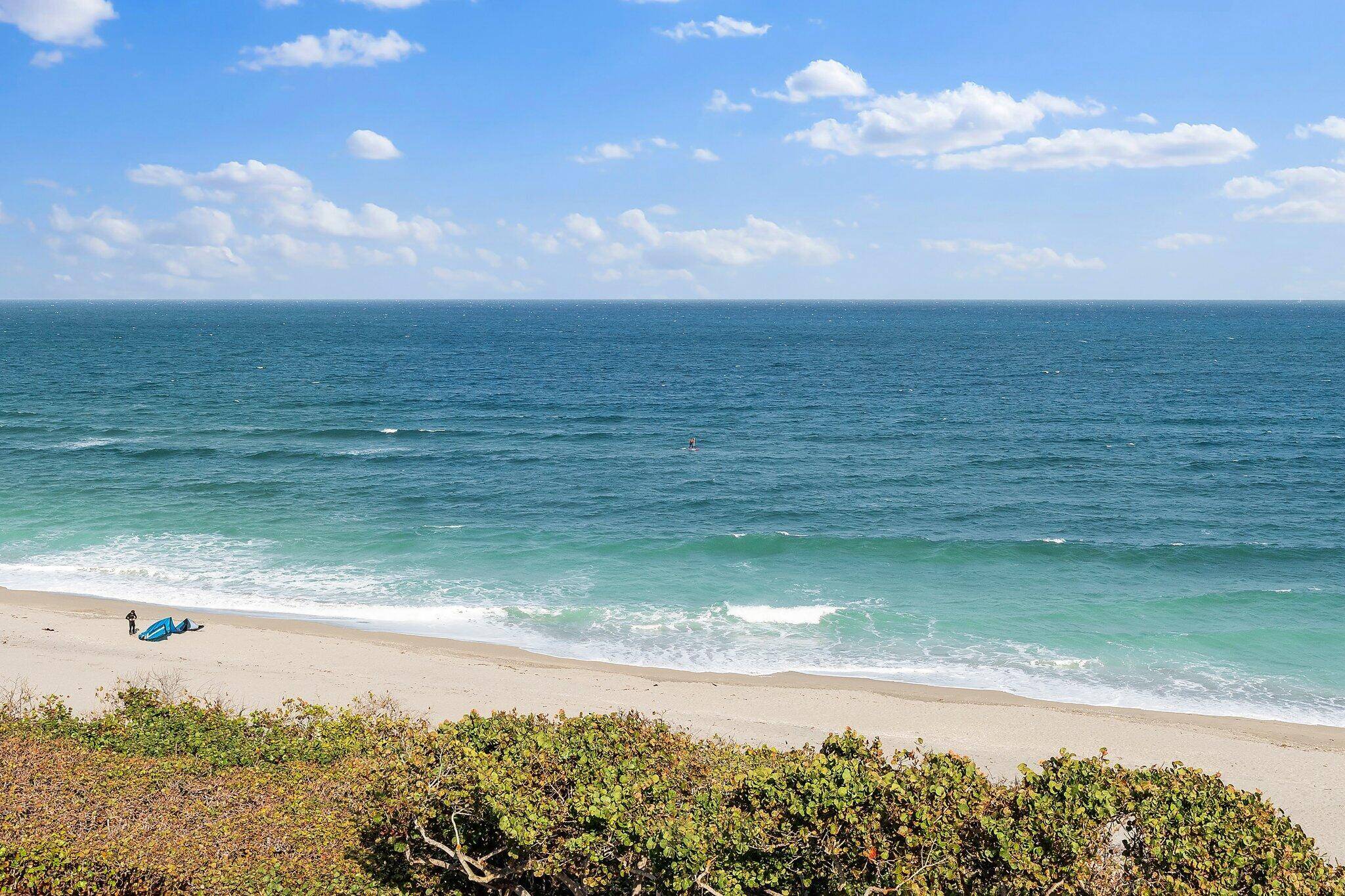 Experience luxury living in this exquisite oceanfront residence boasting breathtaking direct ocean views at Jupiter Ocean Grande.