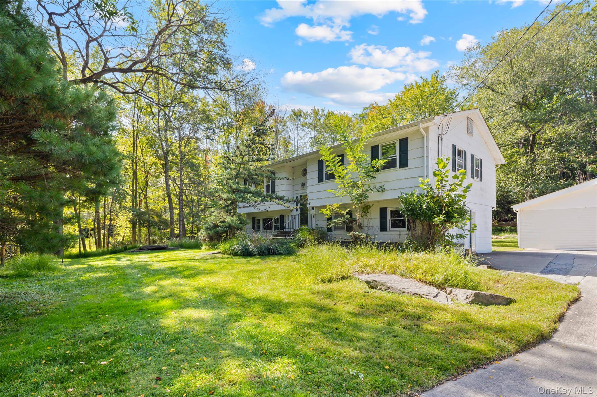 Welcome to this beautifully maintained High Ranch nestled on over an acre of private property.