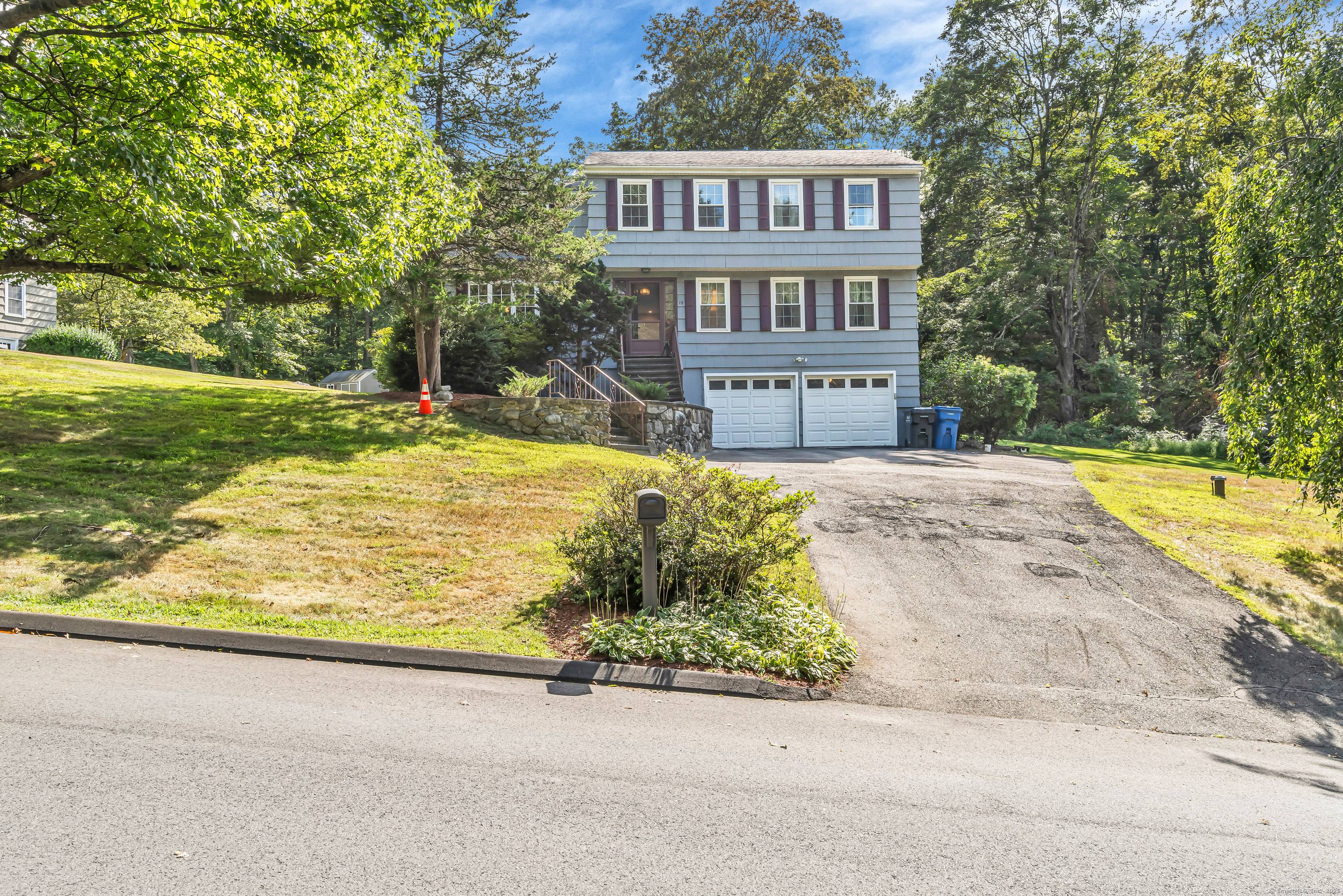 A timeless Colonial that boastfully sits on a perfectly blended grassy and wooded acre lot.