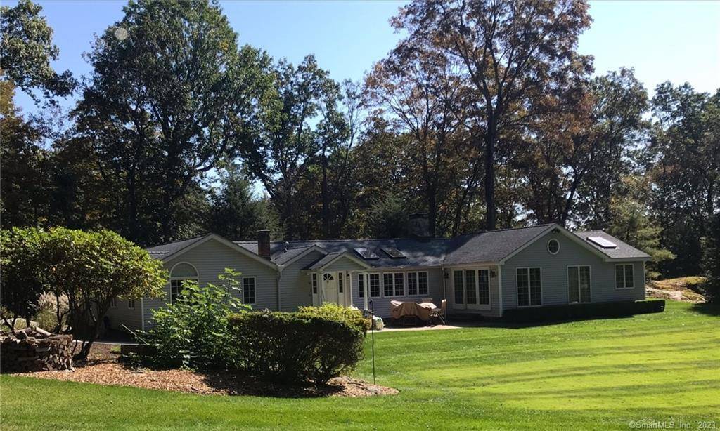 Perched at the crest of a 2 acre lot and bordering protected conservation land, this single level estate offers a rare degree of privacy and quiet.