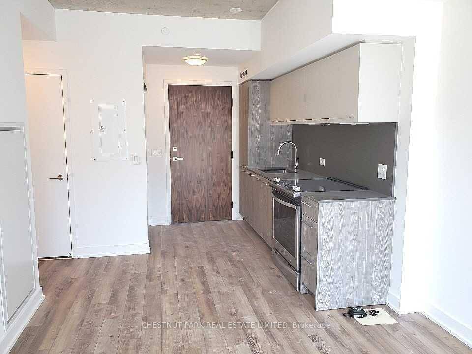 One Bedroom Riverside Condo Features Open Concept Living Dining Room And Modern Kitchen With Integrated Appliances, Stainless Steel Stove Top Oven, High Exposed Concrete Ceilings !