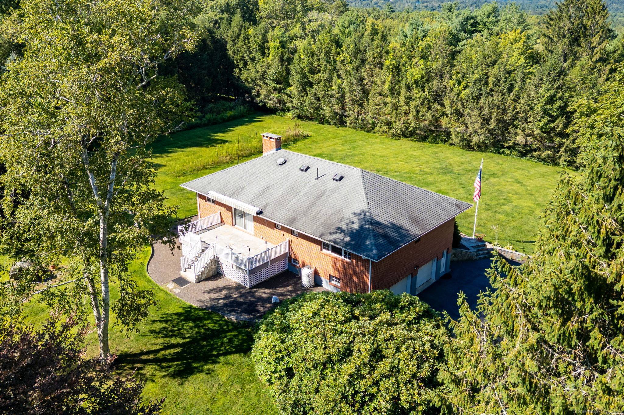 Experience peaceful country living in this charming brick ranch, perfectly positioned on a quiet road amidst beautifully landscaped grounds.
