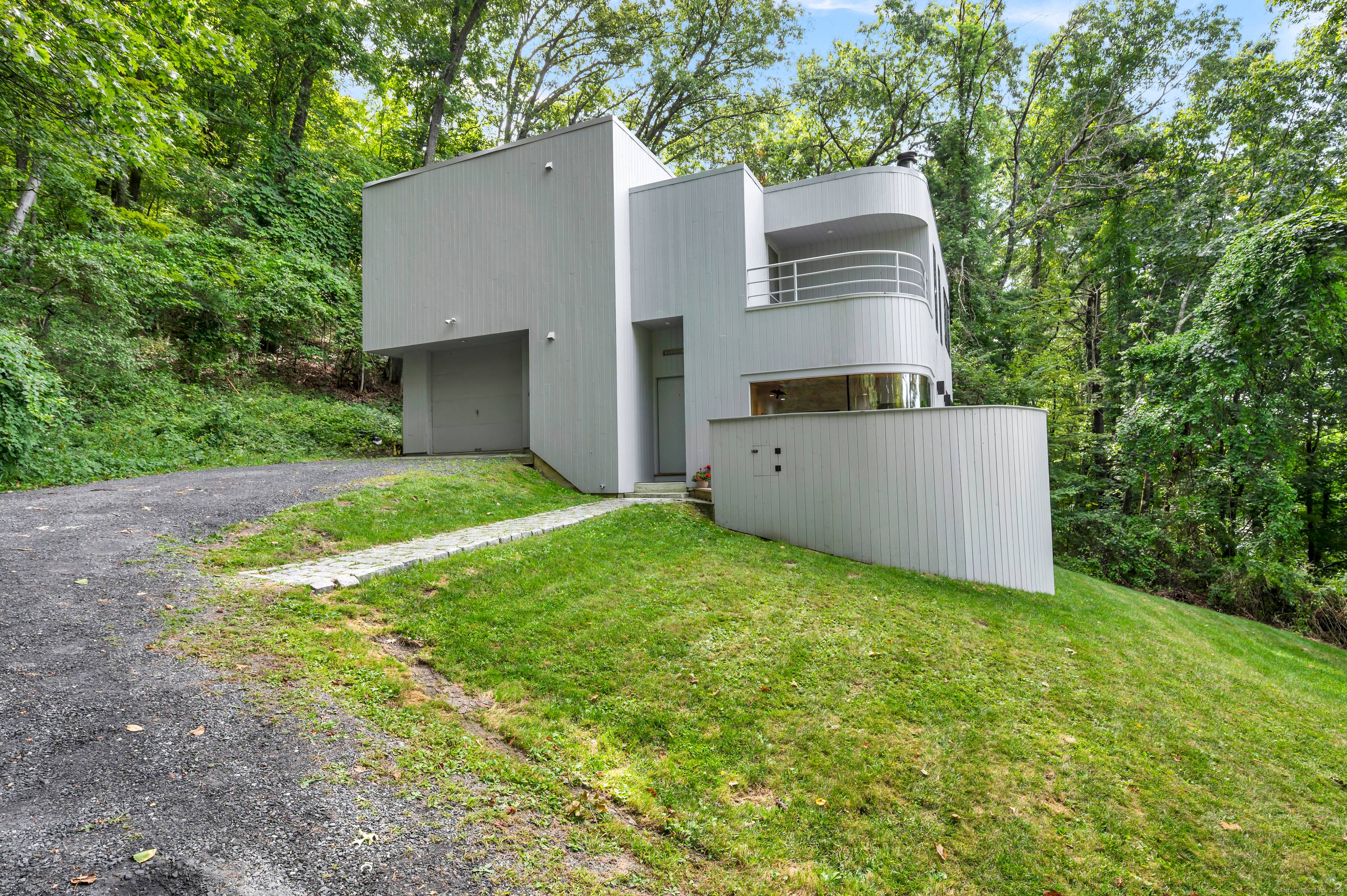 Private Hillside Contemporary with Sweeping Western Views Spectacular architect designed contemporary commanding a private hillside setting with sweeping western views over protected land.