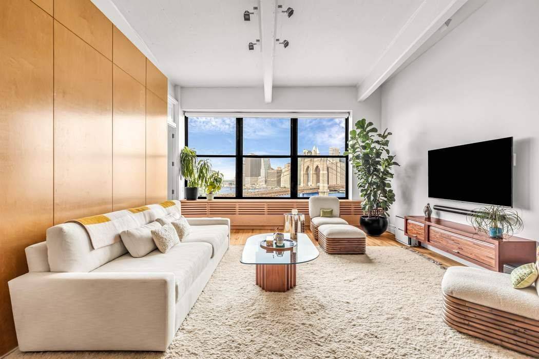 Enjoy breathtaking views of the Brooklyn Bridge, Brooklyn Bridge Park, East River, and the New York City Skyline, all perfectly framed by oversized windows in this truly iconic DUMBO loft.