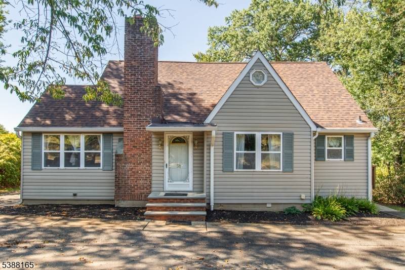 Charming Cape Cod style home with park like deep backyard !