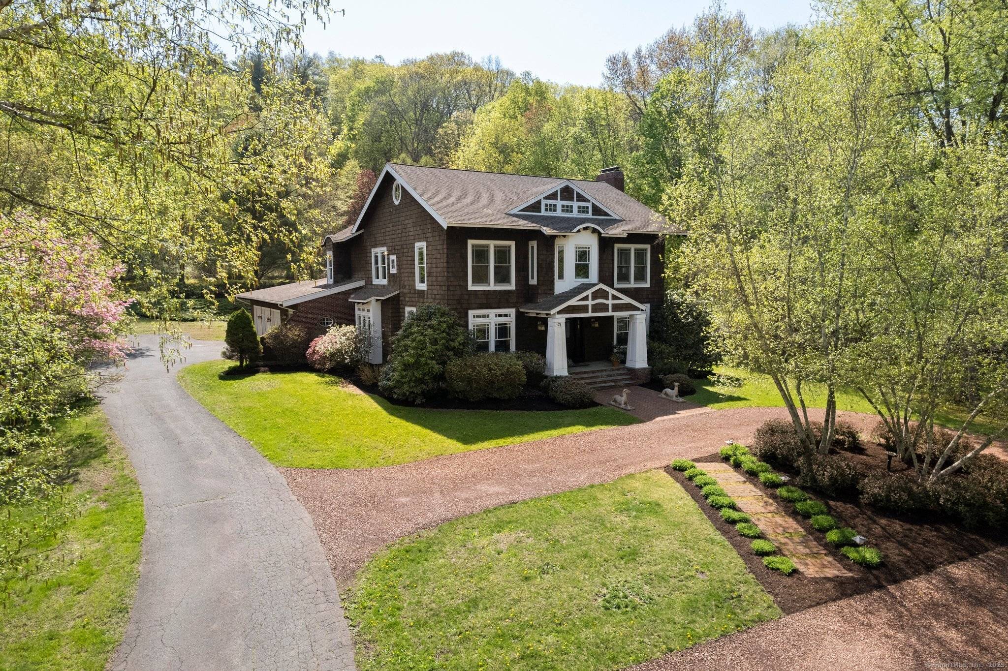 Nestled in Simsbury's East Weatogue Historic District, this notable Arts Crafts home blends timeless New England charm with refined architectural detail.