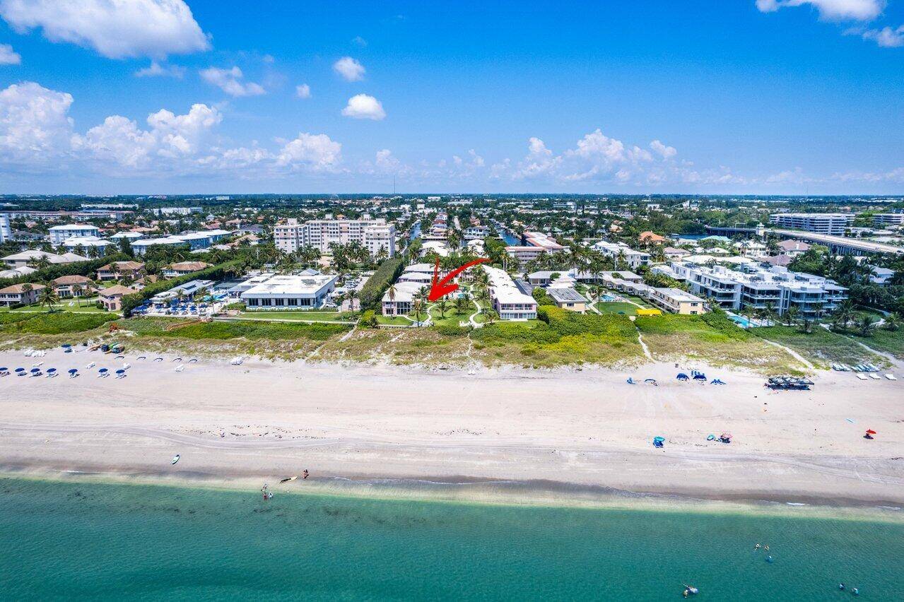 Experience serene seaside living in this inviting bright corner residence showcasing sparkling blue ocean views.