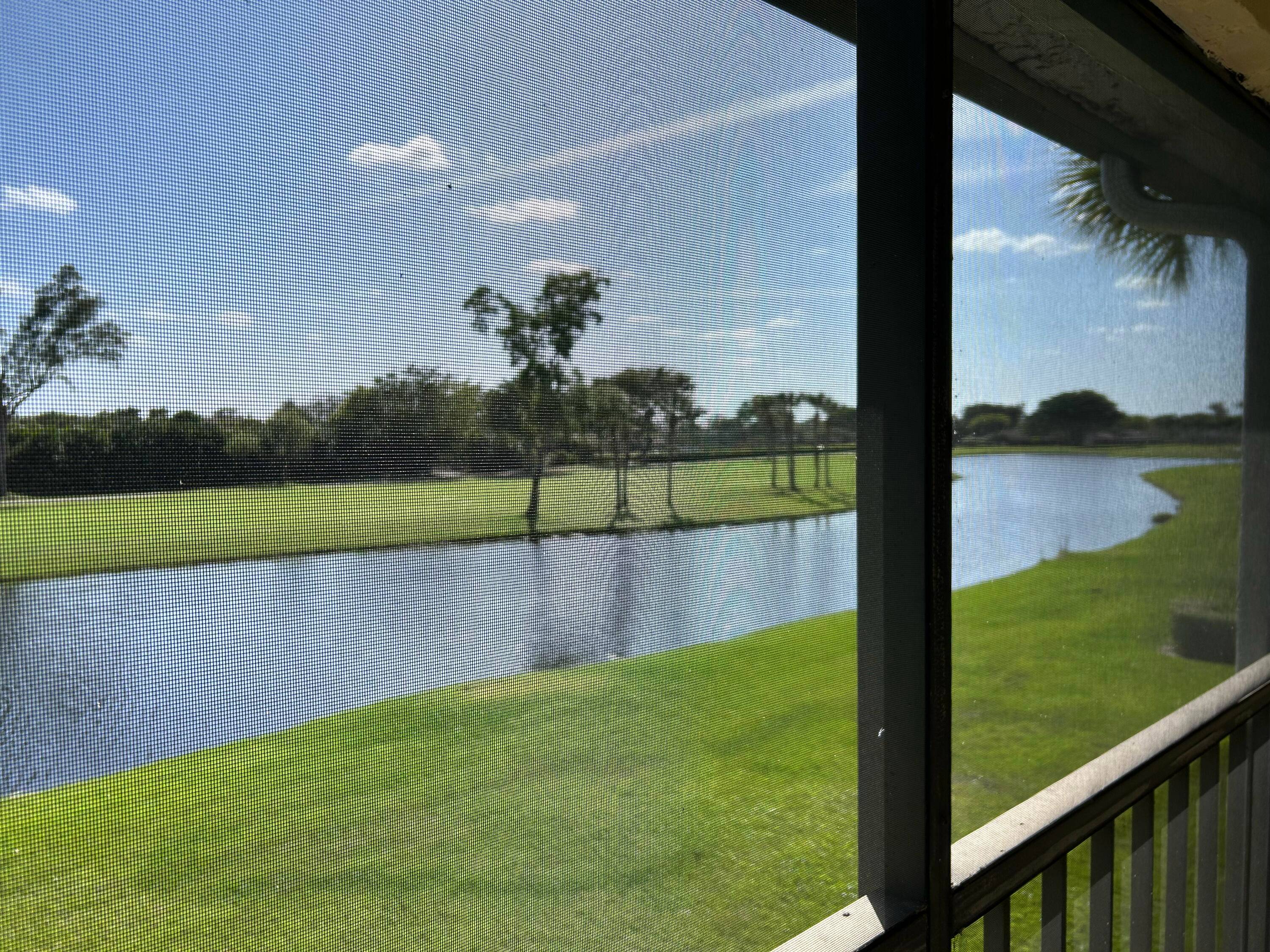 Lake front and golf views from this desirable Cypresses of Boca Lago condo.