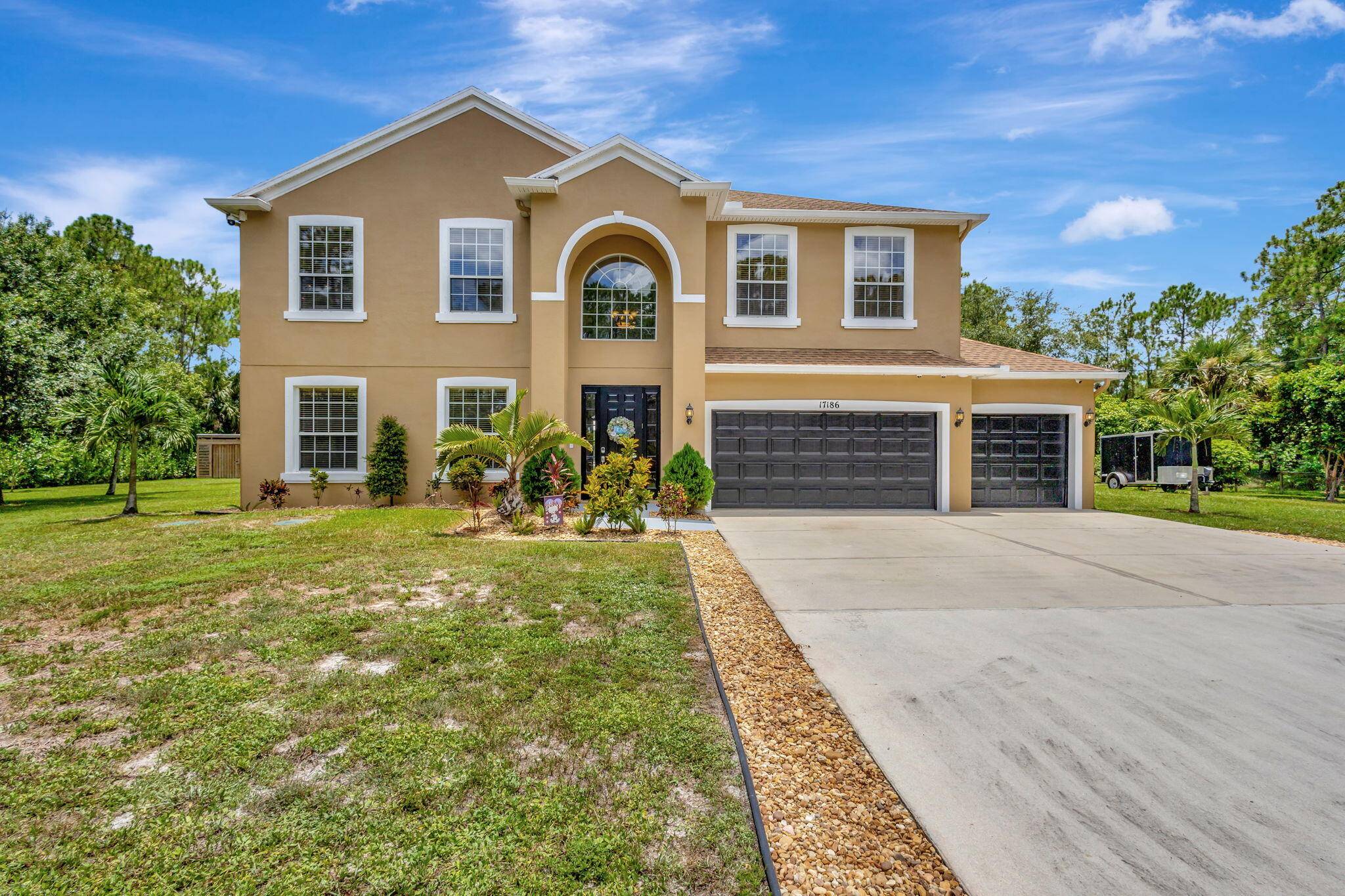 This fully fenced 1. 16 ac home in Loxahatchee is spacious, 2 story, 5 3 3 plus loft den, well maintained, landscaped, cust.