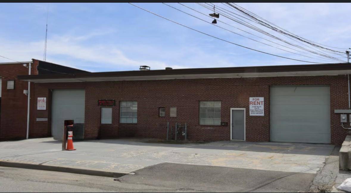 Large warehouse with office and bay door.