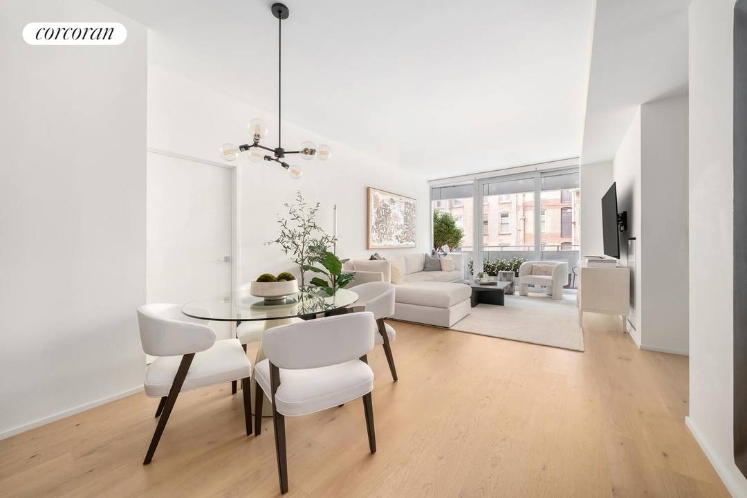Light fills this expansive residence through floor to ceiling windows and glass doors that open seamlessly to the private terrace.