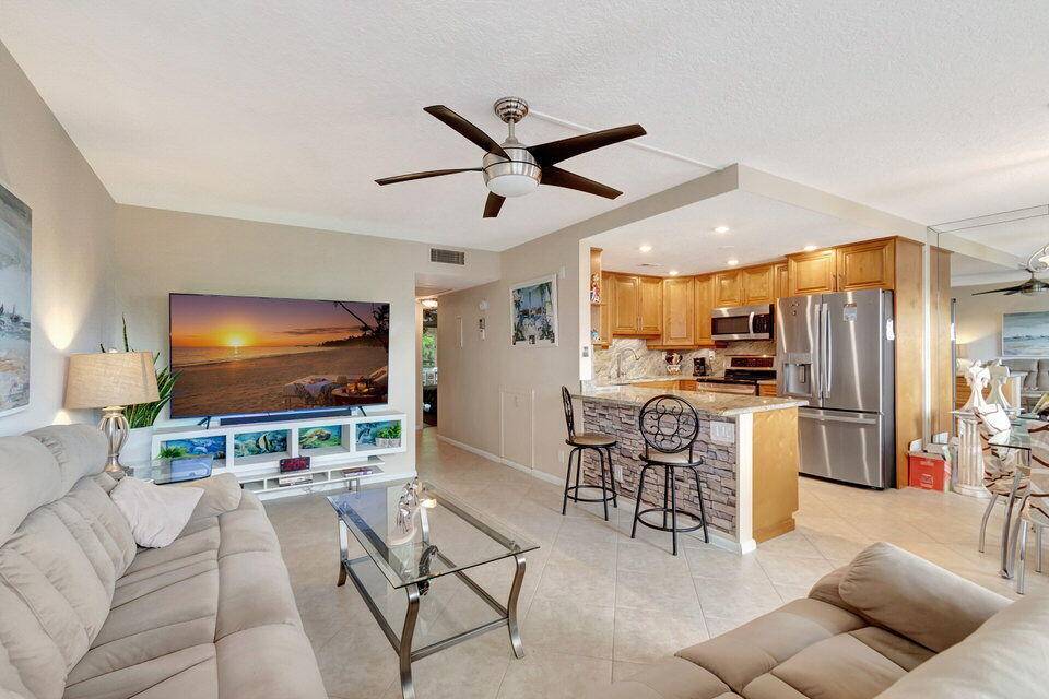 BEAUTIFUL UPDATED 2 2 BRAND NEW AC, OPEN KITCHEN WITH WOOD CABINETS AND STAINLESS STEEL APPLIANCES.