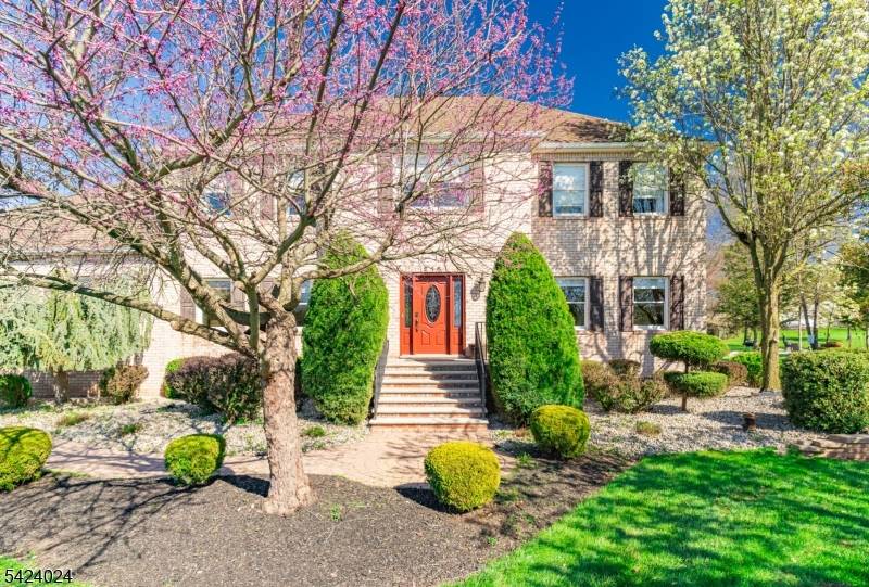 Stunning, meticulously maintained Colonial set on a beautifully landscaped lot with a resort style backyard !