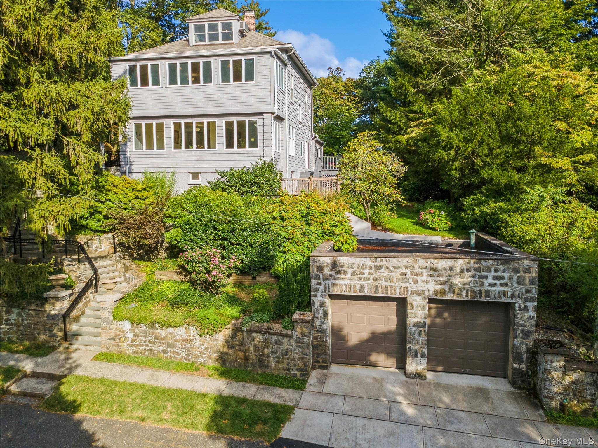 Timeless 1912 colonial home with modern comforts nestled in a peaceful, private setting in the desirable Village of Hastings on Hudson.
