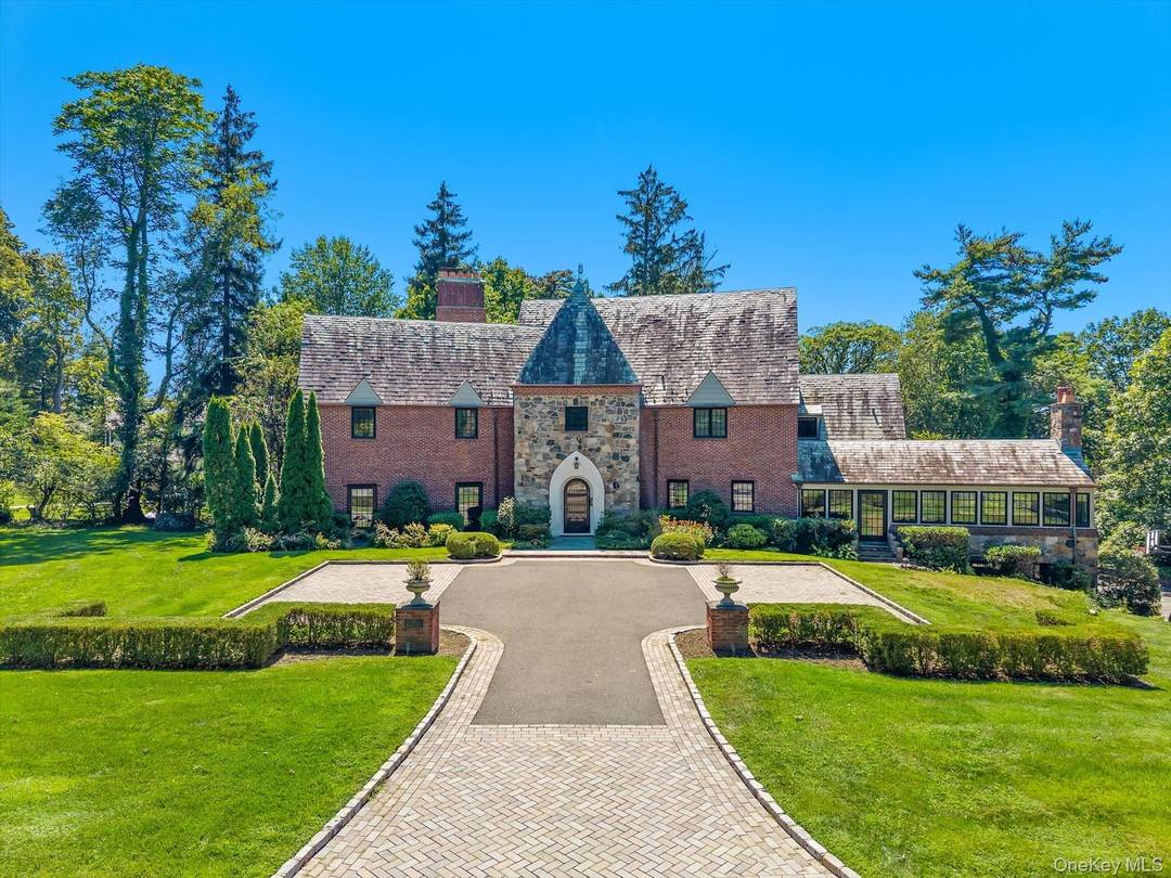 Step into timeless elegance with this one of a kind Tudor residence, perfectly situated in the highly coveted gated community of Kennilworth in Kings Point.