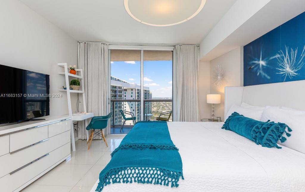 On a high story, with floor to ceiling glass walls, this condo offers stunning city and river views with the bay in the background.