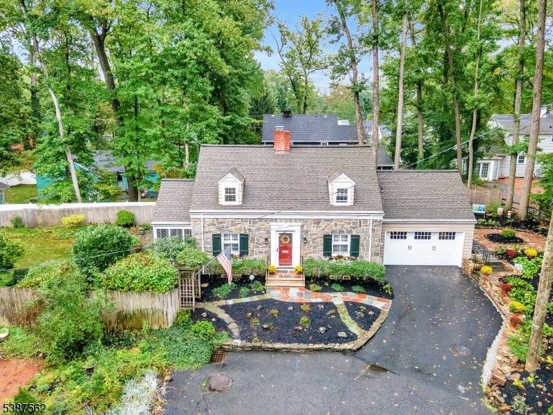 Picture perfect stone front custom Sleepy Hollow Cape Cod style home is nestled on a private hilltop dead end road.