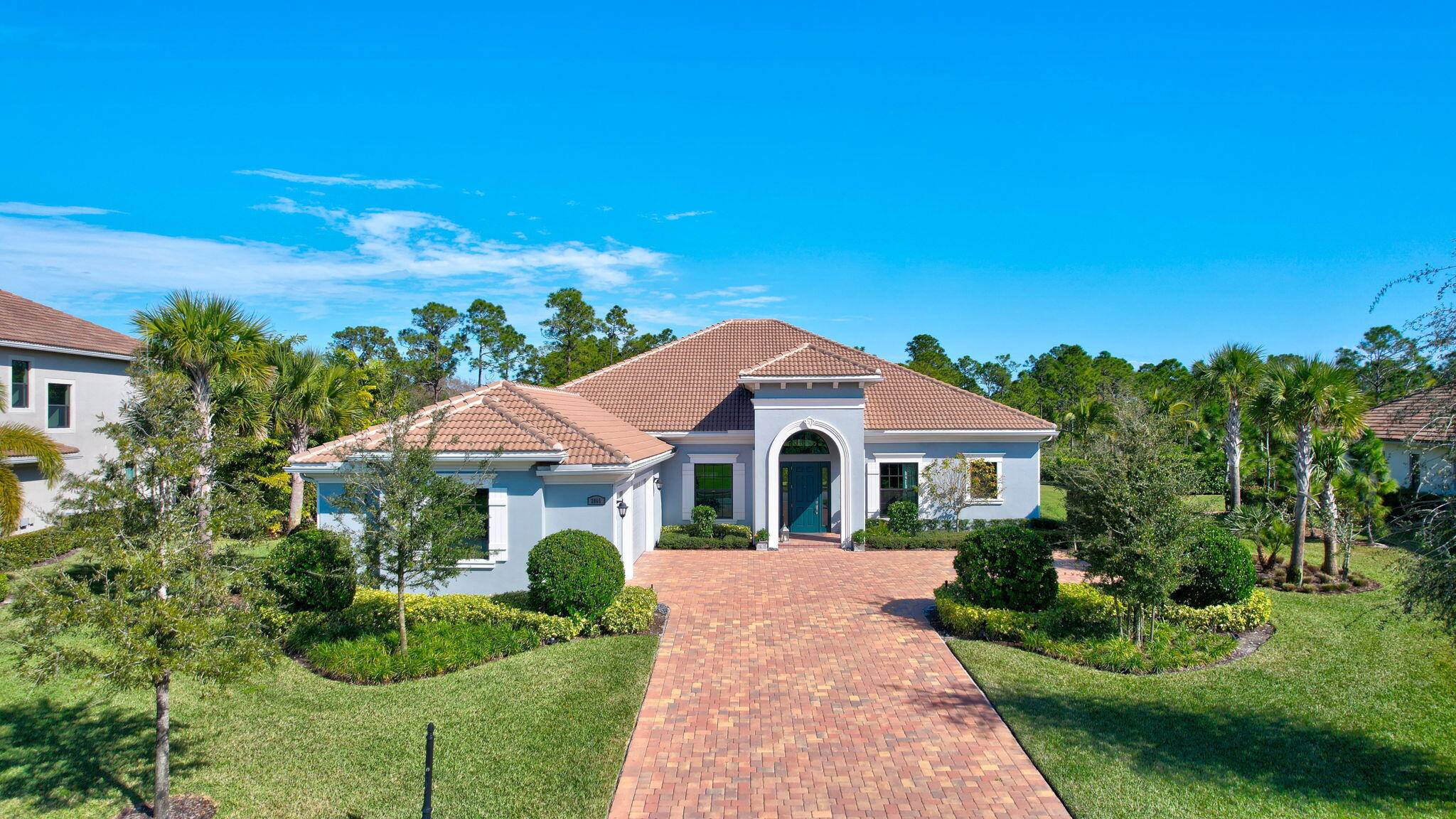 Discover refined Florida living at 2865 SW English Gardens Dr in Palm City's Canopy Creek.